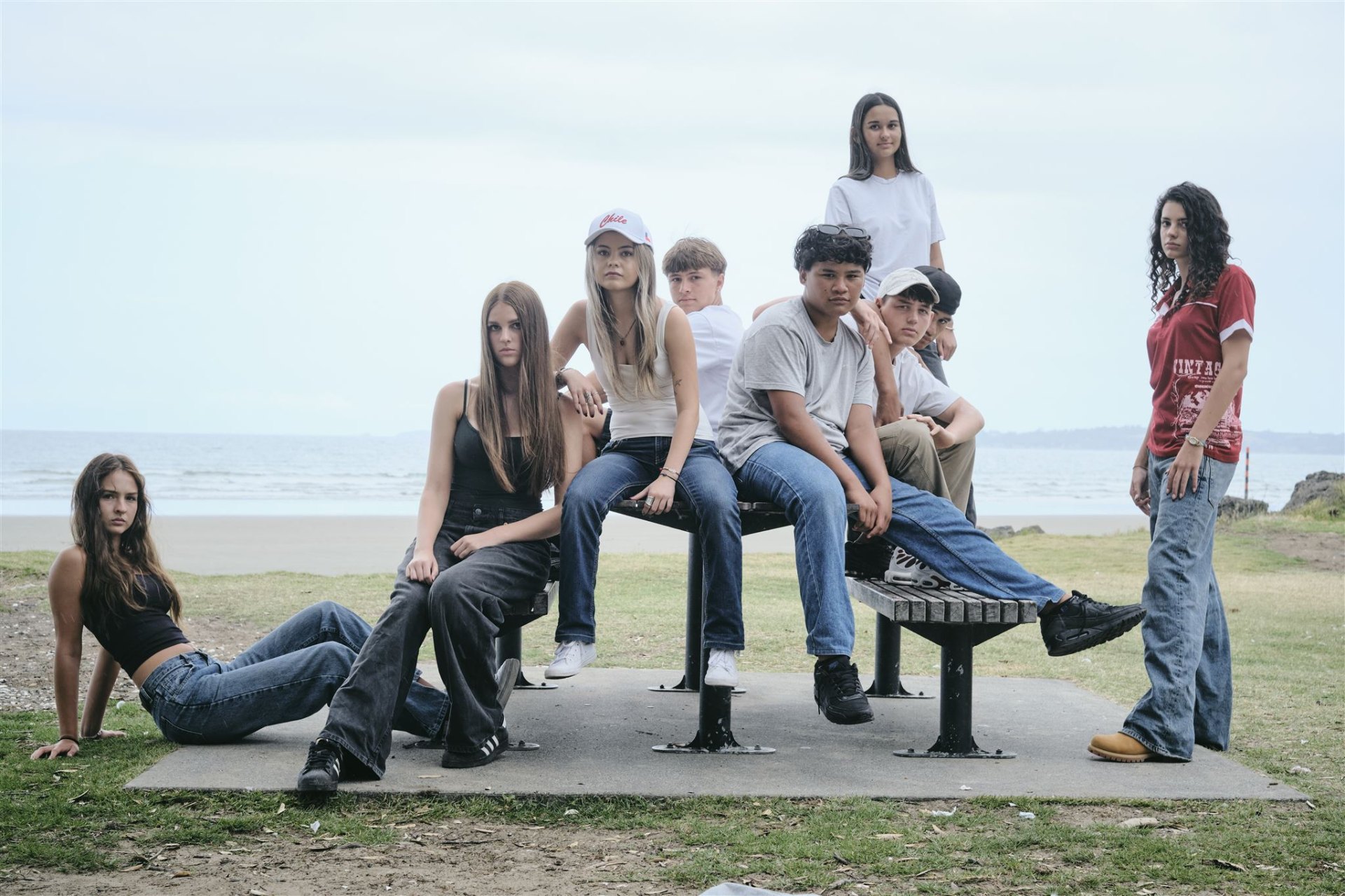 A group of young people together by the beach in Aotearoa